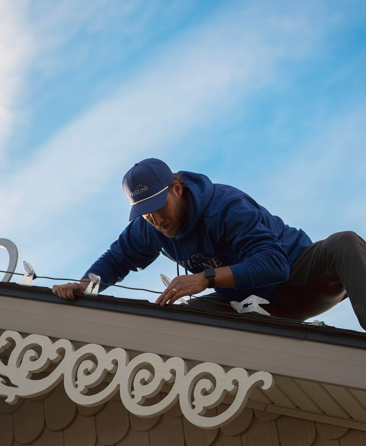 Tate Workman on a roof working on lights