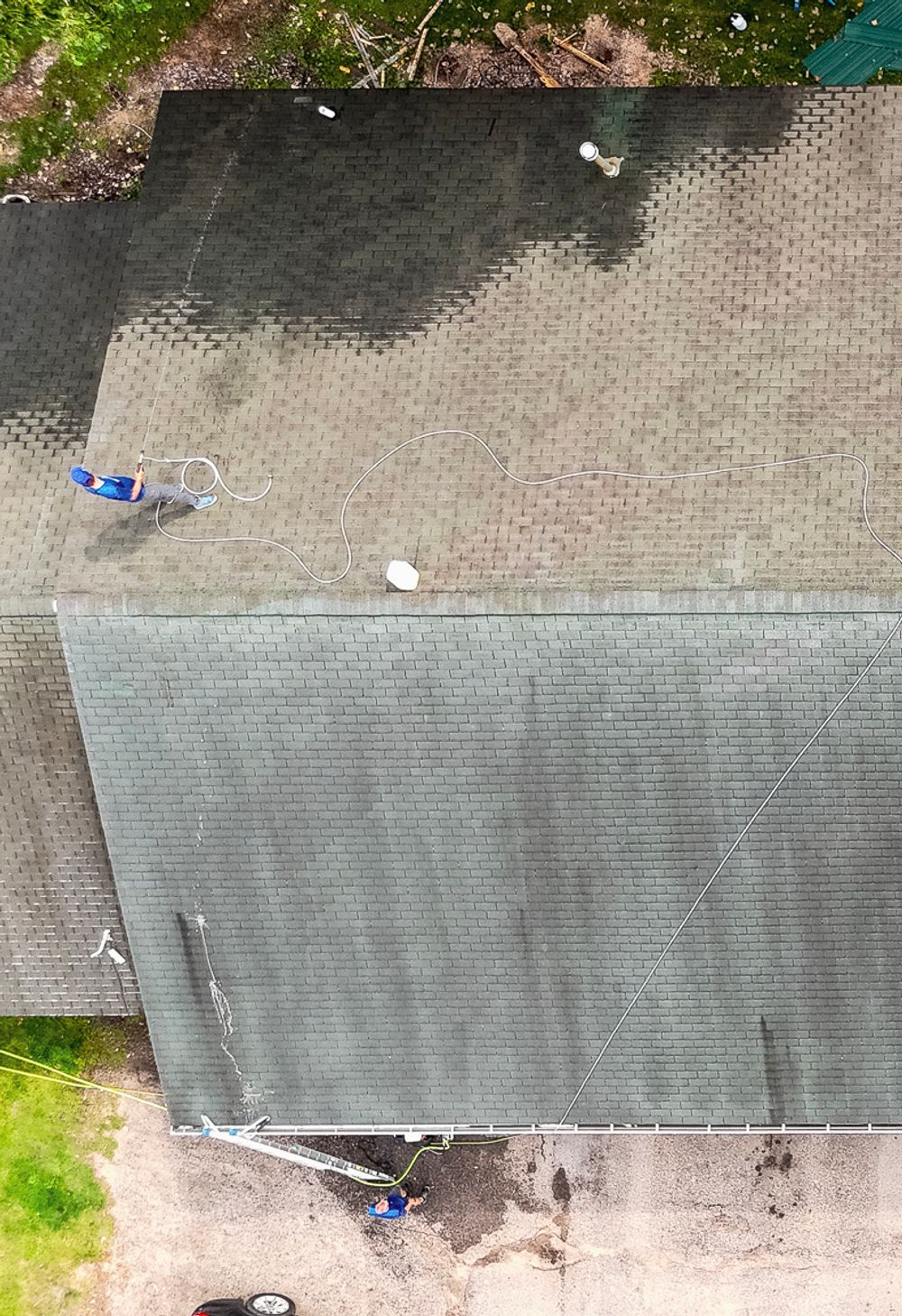 roof with black streaks and algae before cleaning
