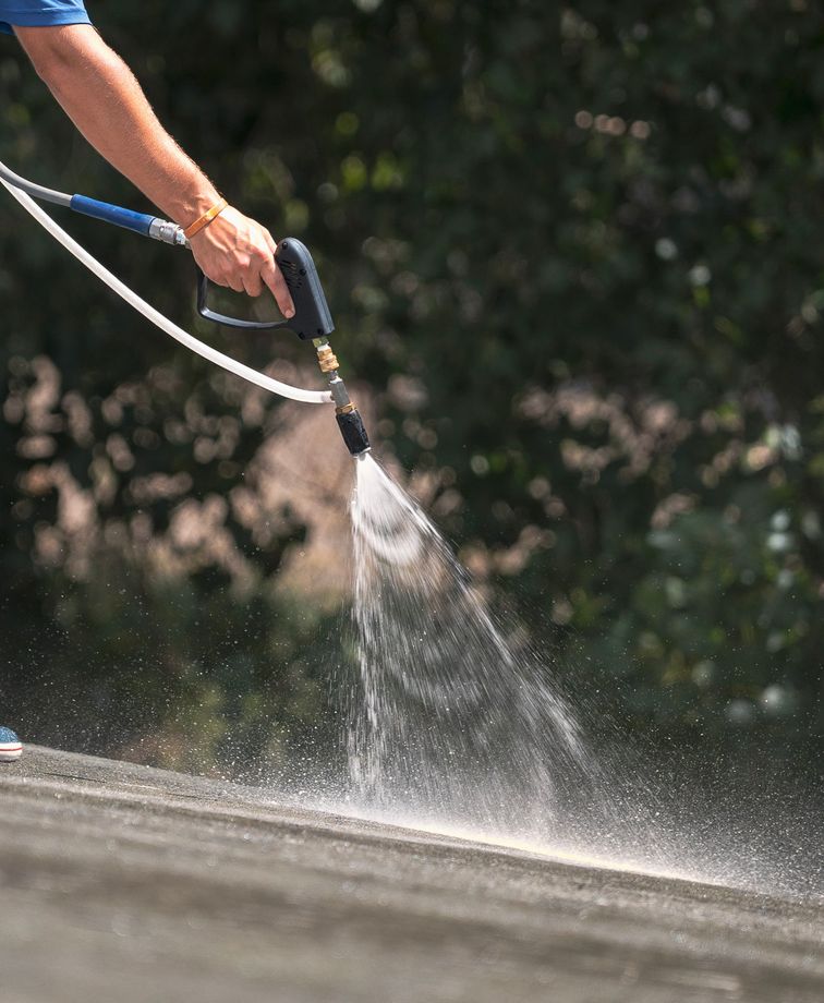 Soft washer on the roof spraying cleaning solution