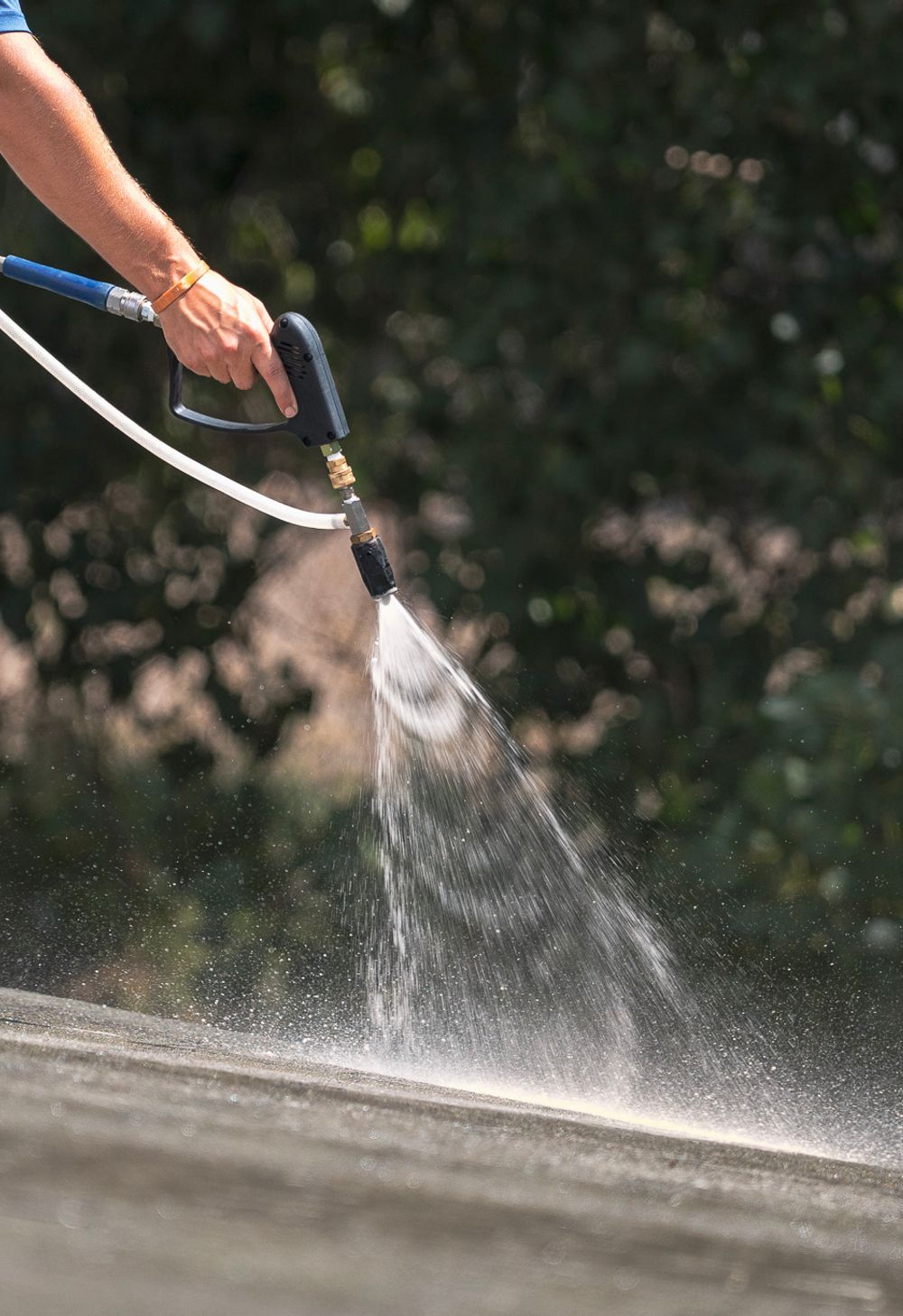 soft washing solution being applied to a roof